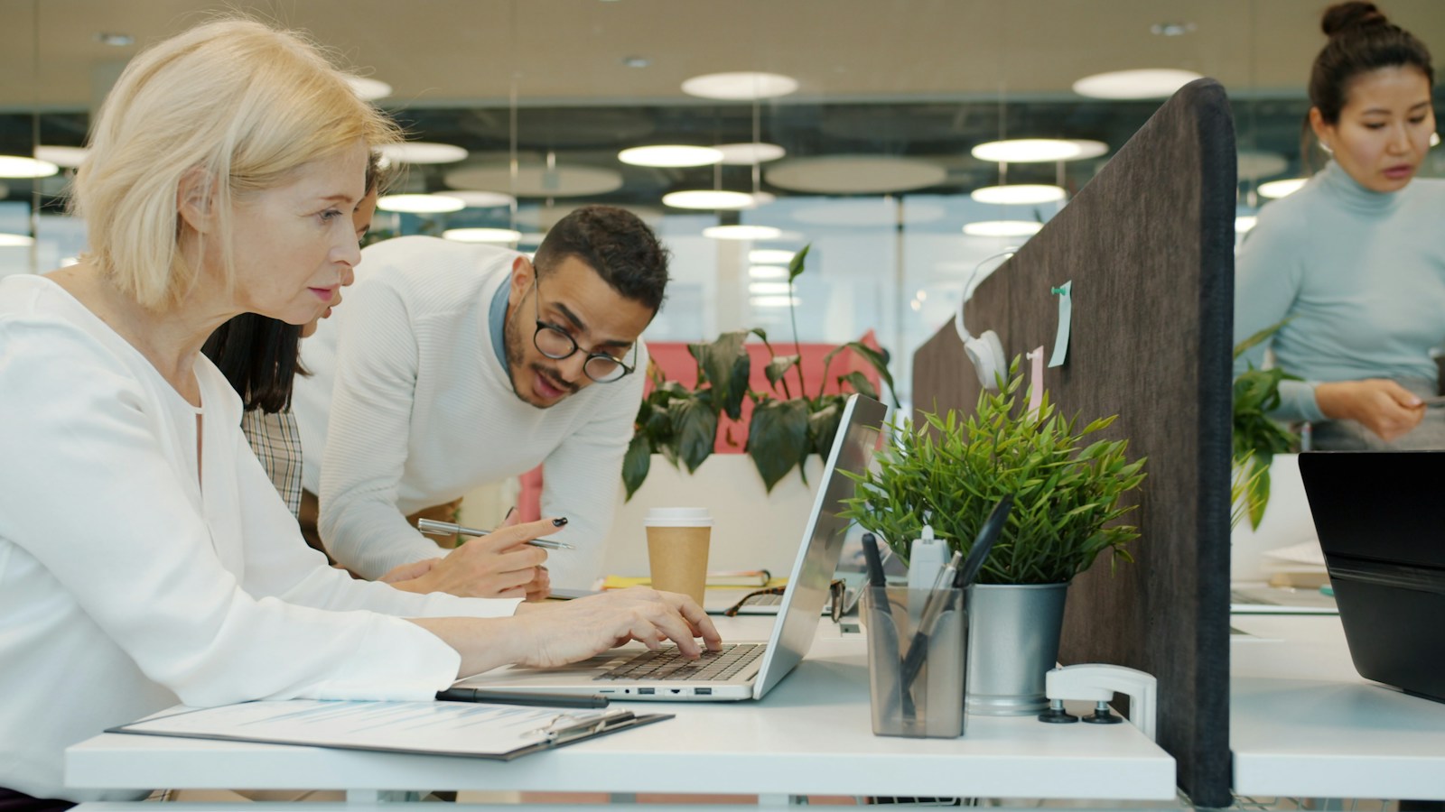 Colleagues reviewing work together in an office